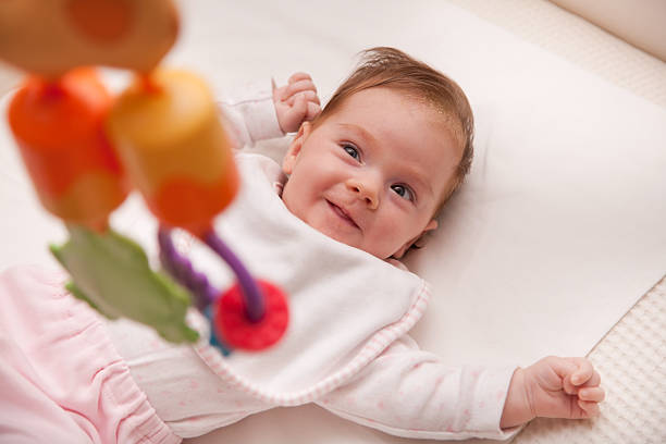 istock Beautiful baby smiling at her toy 174794512