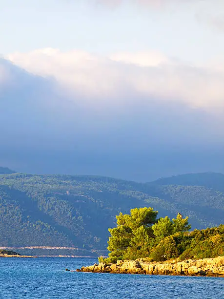 "Sailing near the coast of Korcula with  peninsula Peljesac in background, on cloudy day, Adriatic Coast, Croatia."