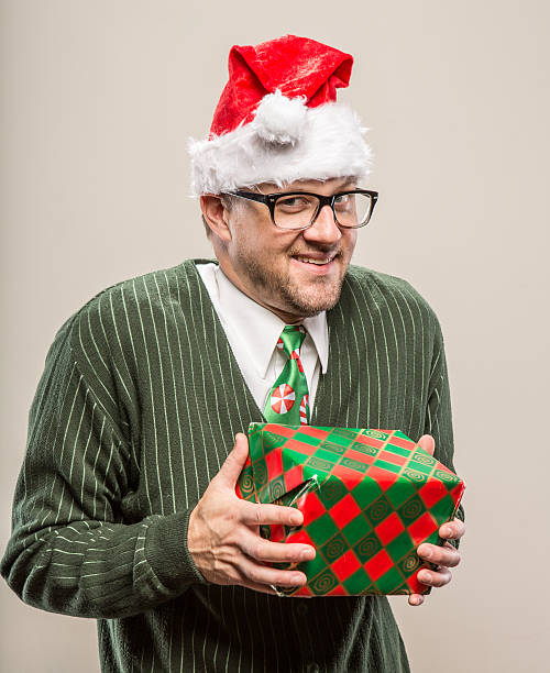 istock Goofy Nerdy Christmas Man holding wrapped gift 174794901