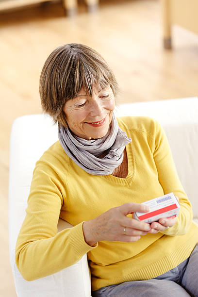 istock Senior woman reading label on medicine 174794951