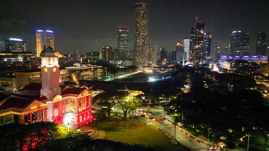 Aerial view of Boat Quay and Singapore skyline from Cavenagh Bridge at night.