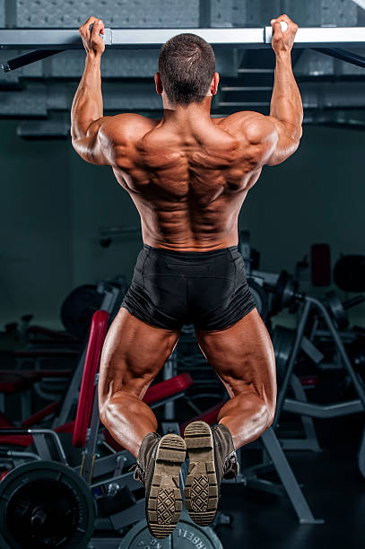 istock Muscular man doing chin-ups at the gym 174795180