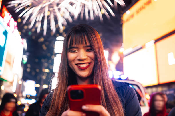 New Year celebrations in Times Square, New York Woman taking part of a public celebration New Year event in New York City. times square new years eve stock pictures, royalty-free photos & images