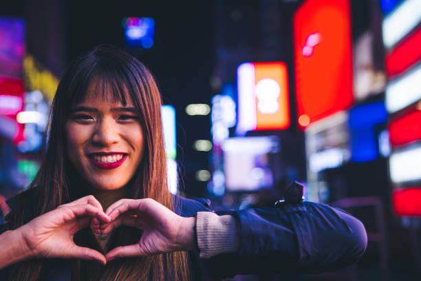 istock Taiwanese woman making a heart shape to camera 1747956017