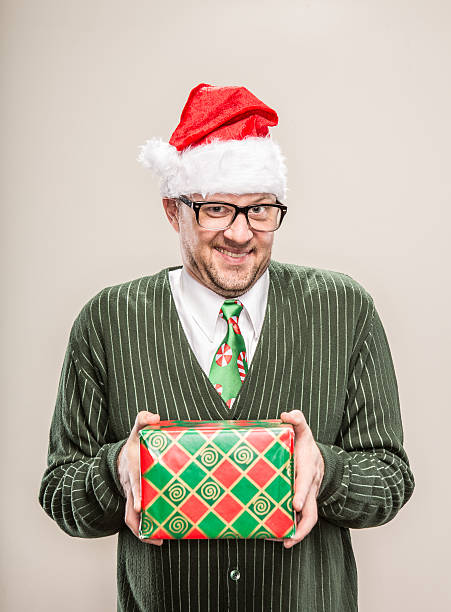 istock Awkward Nerdy Christmas Man holding wrapped Holiday gift 174796032