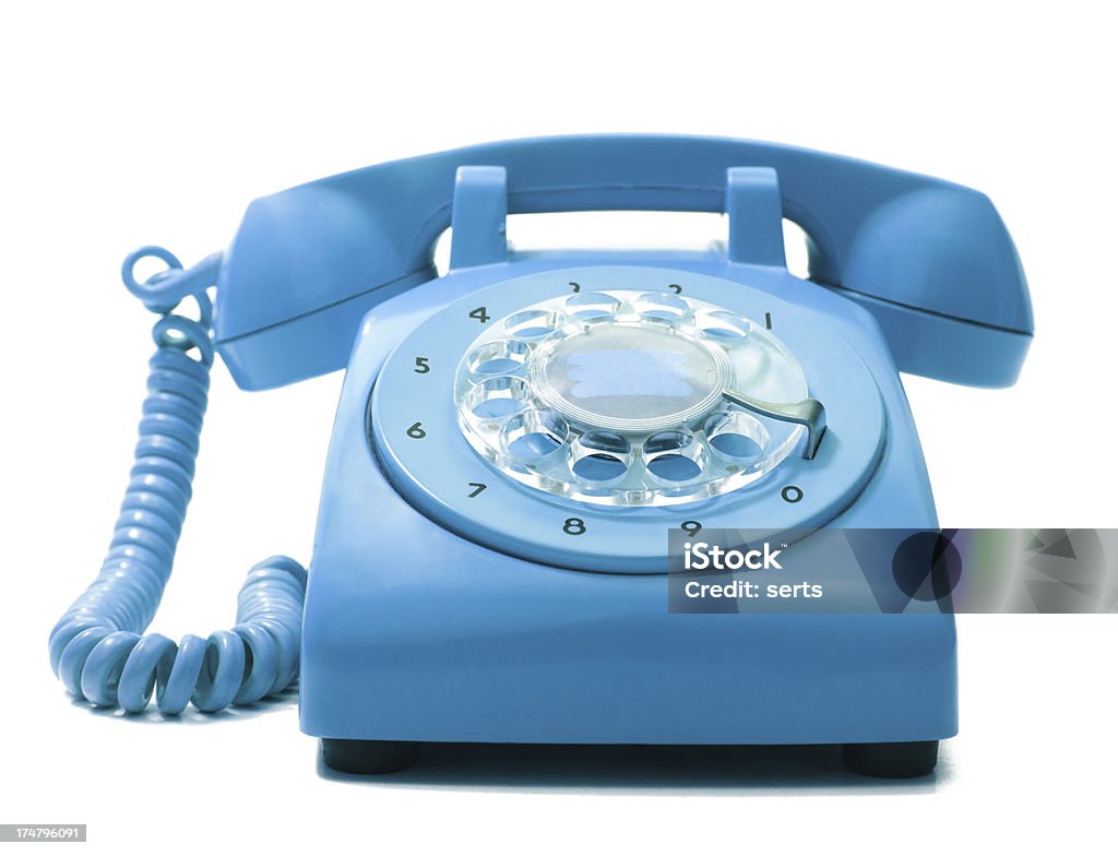Old Phone Old-fashioned blue telephone on a white background. Telephone Stock Photo