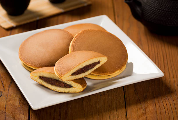 Dorayaki or Japanese Sweet Bean Pancakes with Tea Dorayaki are Japanese pancakes filled with sweet bean paste, usually served with hot tea. adzuki bean photos stock pictures, royalty-free photos & images