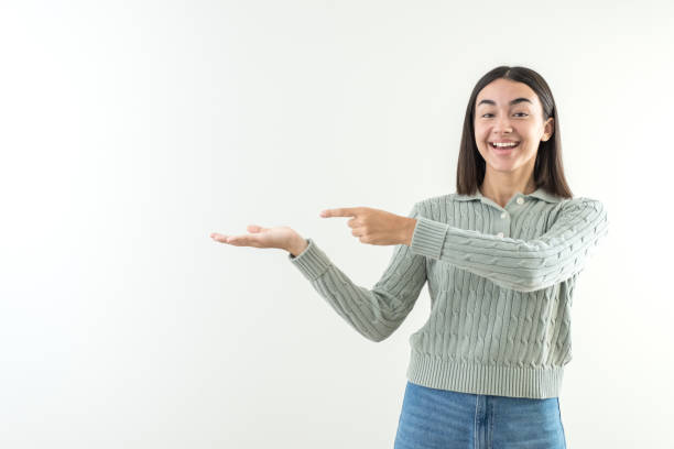 istock Happy girl offering and presenting a product or message over hand in empty space copy 1747965426