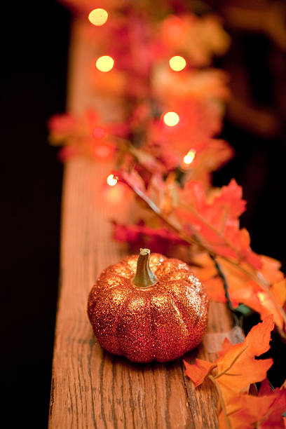istock Festive Fall Decorations of Pumpkin, Autumn Leaves, and Lights 174796705