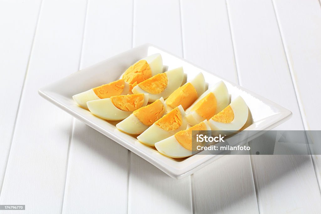 Slices of hardboiled eggs Slices of hardboiled eggs on a tray Appetizer Stock Photo