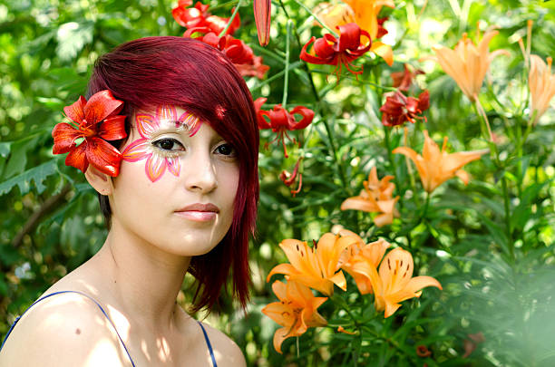 Beautiful teenage girl in princess outfit on a walk. She is hiding in the foliage lost in the forest. Shooting on a summer night in a forest area