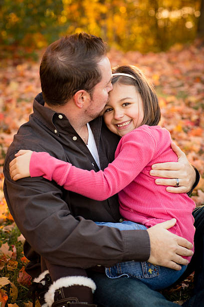 istock Happy Father and Daughter Cuddling Outside on Beautiful Fall Day 174797453