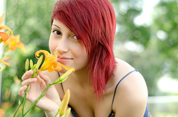 Horizontal outdoor garden shot in soft light of young mixed race woman.