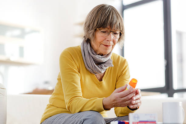 istock Senior woman reading label on medicine 174797538