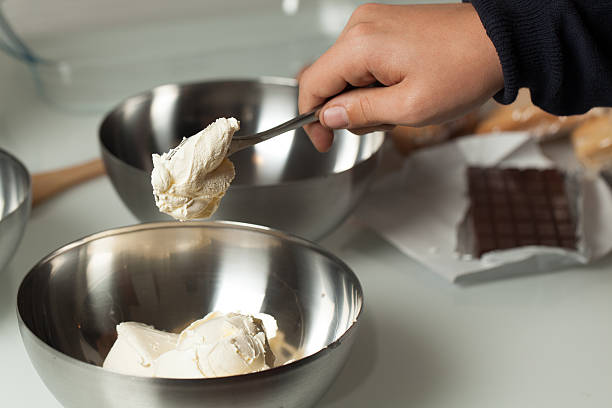 istock Teenager's Hand Pouring Mascarpone into a Bowl 174797573