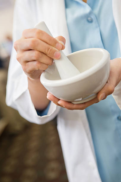 Pharmacist compounding prescription drugs to create custom medication