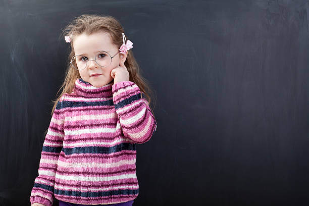 istock Cute girl in front of a chalkboard 174798046