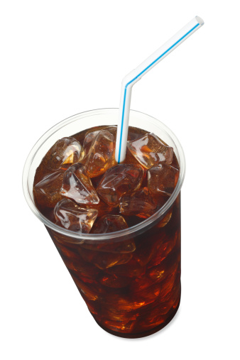 cup of iced coffee with straw isolated on white background (clipping path)Glass with alcohol and ice cubes.