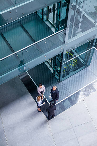 Top view of business people talking Top view of business people talking outdoor elevator stock pictures, royalty-free photos & images