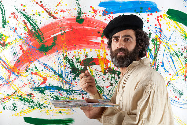 Artist adult man standing before painting