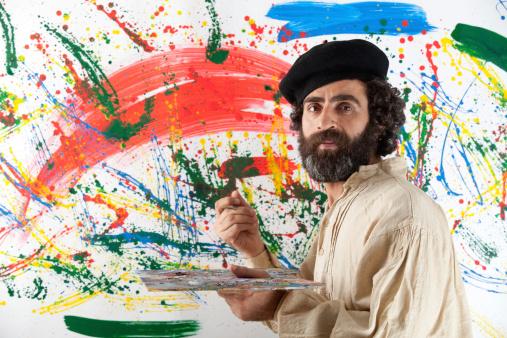 Artist adult man standing before painting