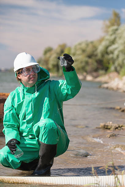 istock Environmentalist looking at sample of polluted water 174798279