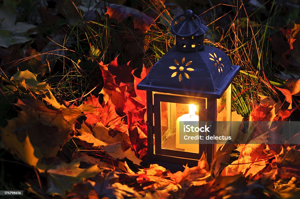 Lantern in the autumn leaves Warm candlelight in the autumn leaves. Autumn Stock Photo