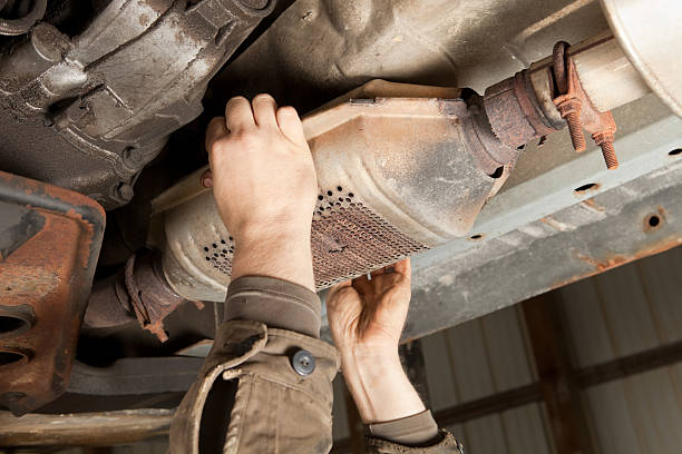Catalytic Converter Removal at a Salvage Yard stock photo