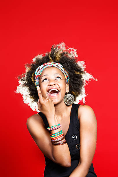 istock Pointing up at blank space, cute young woman laughs happily 174799123