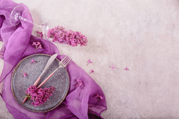 istock Table setting with drinking glass full of lilac flowers 1747996696