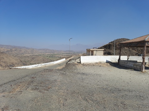 Saudi Arabia, Al-Baha, 10-21-2023, a mountain road ascending to the upper part of Al-Hajara Park,umbrella,seats for families, The city of Al-Hajara is characterized by being surrounded by \nmountains on all sides.