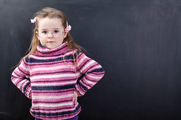 istock Cute girl in front of a chalkboard 174800731