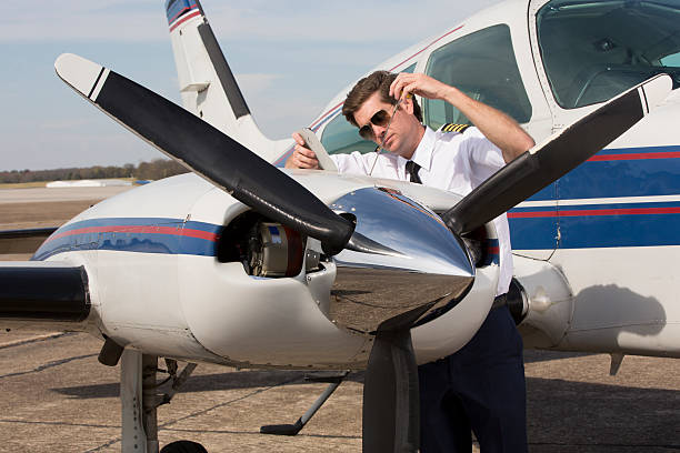 istock Corporate Jet pilot checking oil levels 174801179