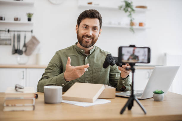istock Impressed blogger recording video about joystick unpacking 1748016285
