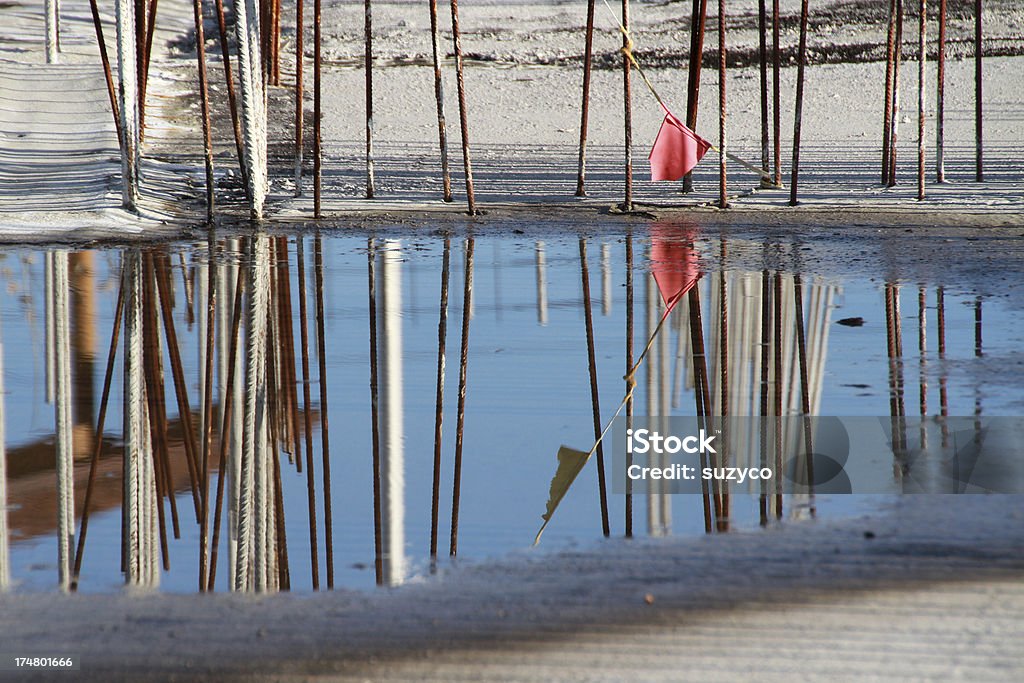 construction site reinforcing bars in construction site with reflection in water Blue Stock Photo