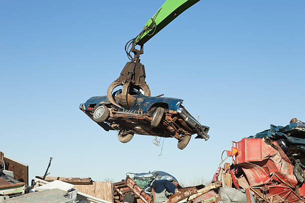 istock Salvage Yard Grappling Claw Gripping Scrap Car 174801703