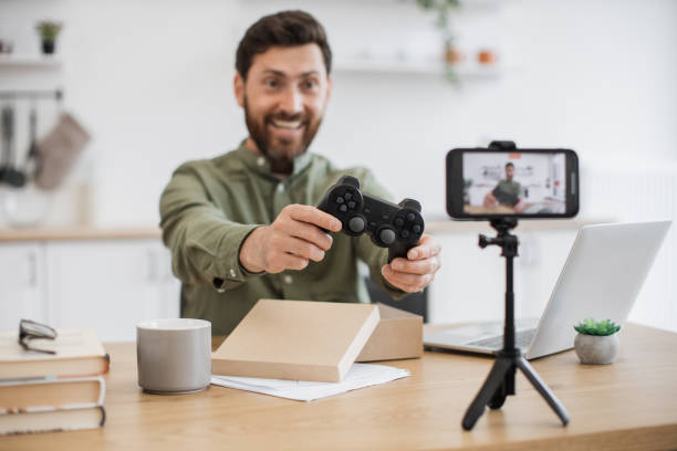 istock Influencer doing livestreaming while unboxing new joystick 1748017364