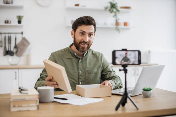 istock Young man recording new video about unboxing technologies 1748017368