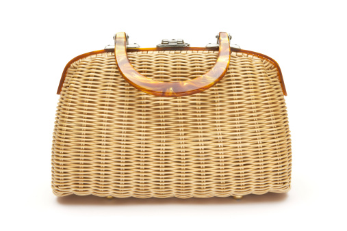 Old woven handbag isolated on a white background.