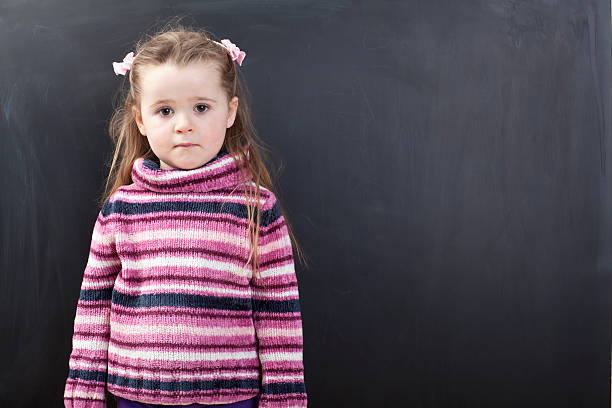 istock Cute girl in front of a chalkboard 174802647