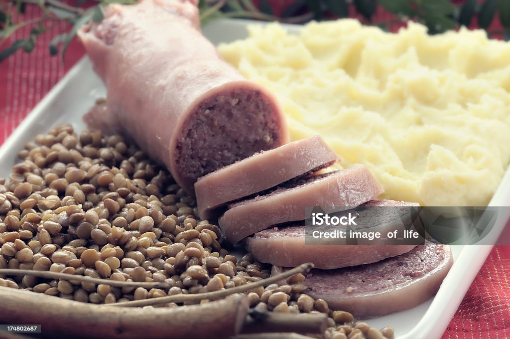 Pig's trotter with mashed potatoes and lentils Zampone with mashed potatoes and lentils - Table decorated for Christmas.Typical Italian cuisine Zampone Stock Photo