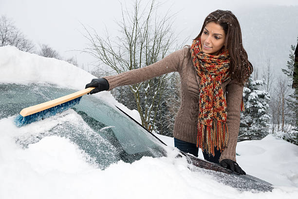 istock Woman freeing her car from Snow 174803155