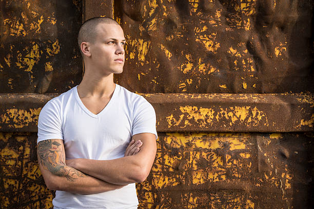 pensive young man with arms crossed