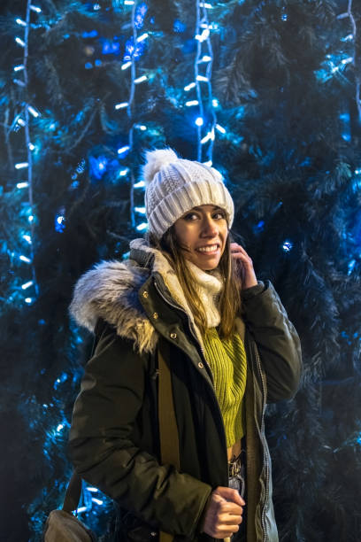 istock Girl smiling next to a Christmas tree. 1748035724