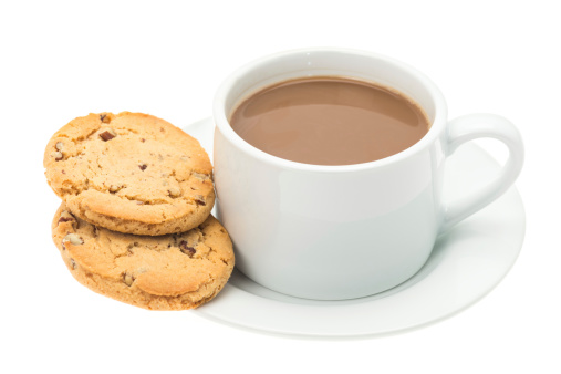 White coffee with two chocolate and nut cookie biscuits - studio shot with a white background