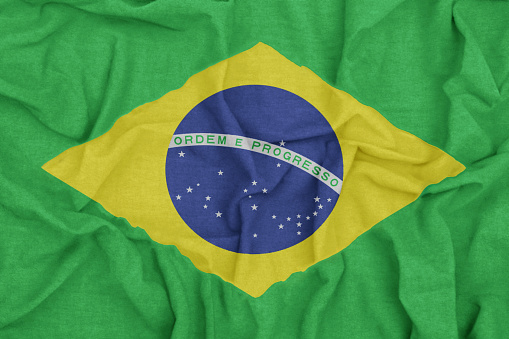 Brazilian Brazil flag with vibrant colors and fabric background