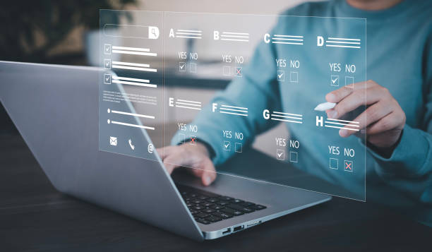 istock Businessman using a laptop and Taking an assessment, questionnaire, evaluation, online survey online exam Choosing the right answer in exam by filling out the online survey form,Answer  test questions 1748044312