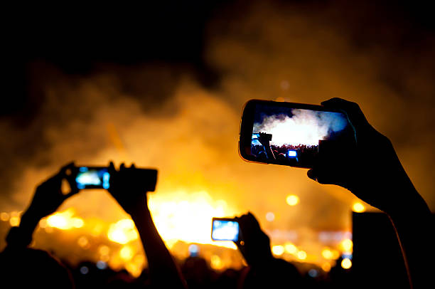 istock Spectators using their mobile phones to take a fire scene 174804577