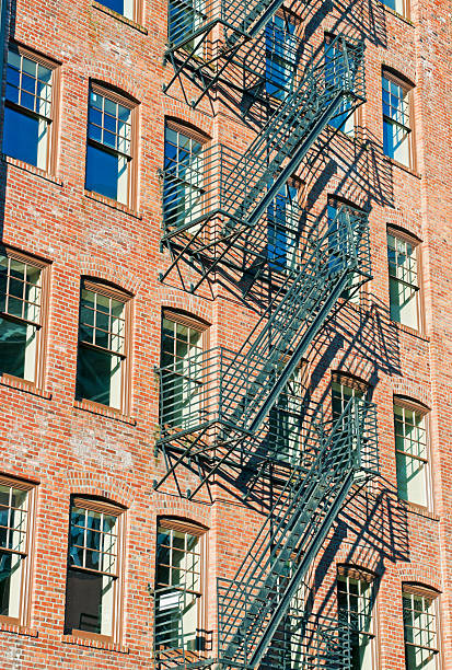 istock Fire escape stairs on facade of old brick building 174804979