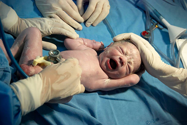 istock Newborn baby being checked by doctors 174805253